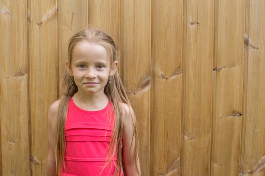 Little girl over a wooden background photo