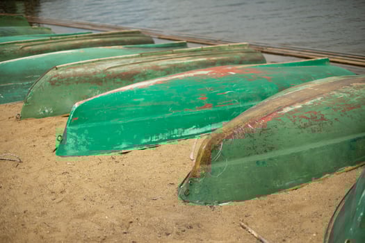 Old boats are overturned on shore. Boat station. Boats are drying up. photo