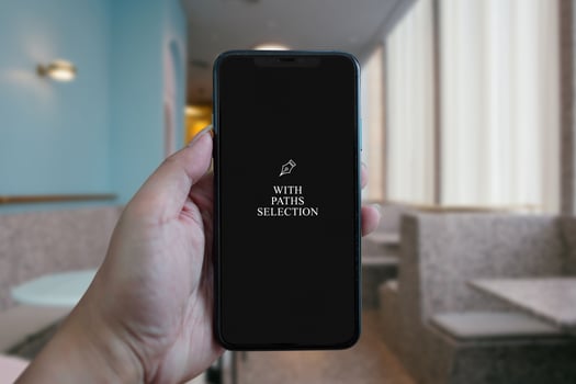 A woman hand holding phone device mockup in the cafe background. photo