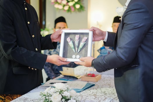 Two Men Holding Wedding Gift Box in a Traditional Wedding Ceremony in Indonesia photo