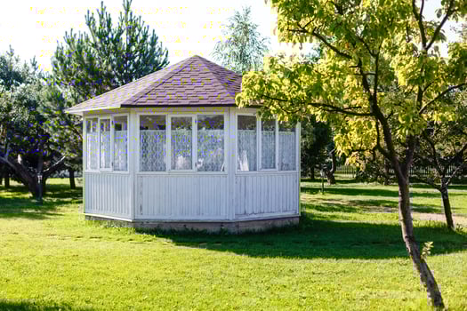 White pavilion in the garden. photo