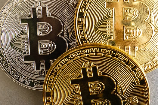 Bitcoin upright on a laptop keyboard photo