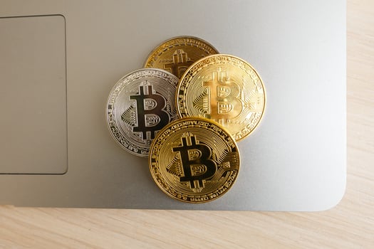 Bitcoin upright on a laptop keyboard photo