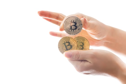 hand holds three coins of digital currency bitcoin photo
