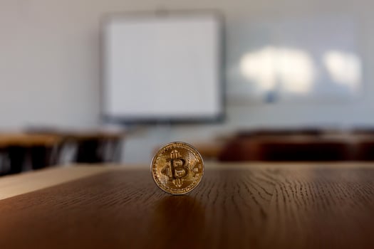 Single bitcoin coin in wooden desk close up photo