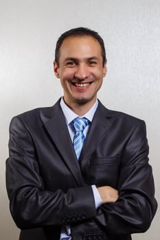 Young and attractive businessman standing against a white background wearing a jacket photo