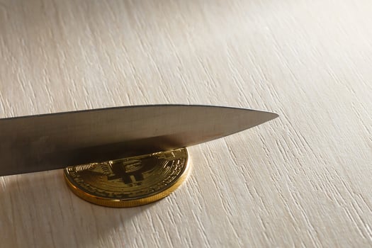Blade of a knife on a gold coin bitcoin photo