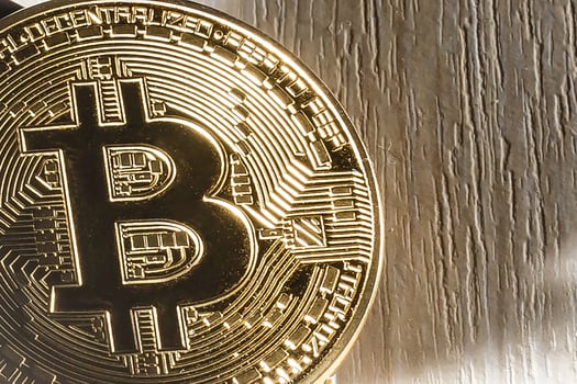 Golden bitcoin on spoon photo
