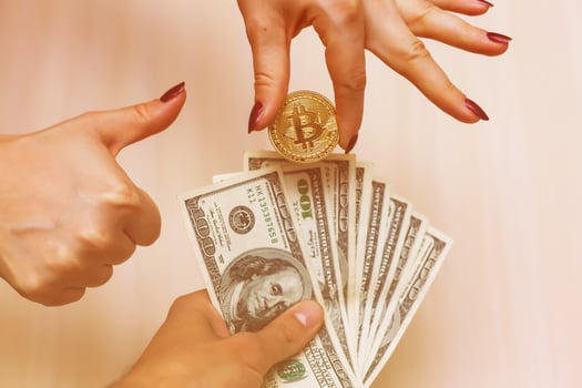 Golden bitcoins on us dollars in the hands electronic money exchange concept photo