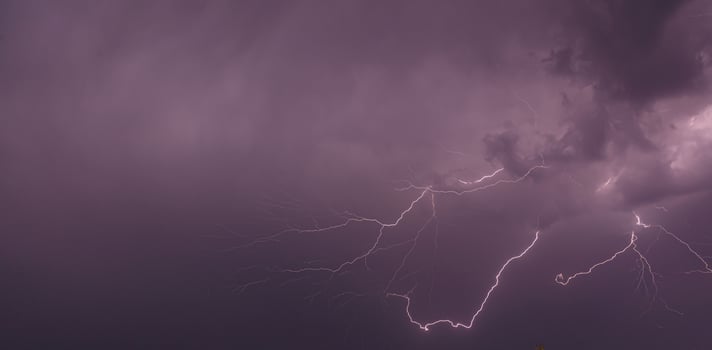 Picture of a flash in the night sky with glowing clouds photo