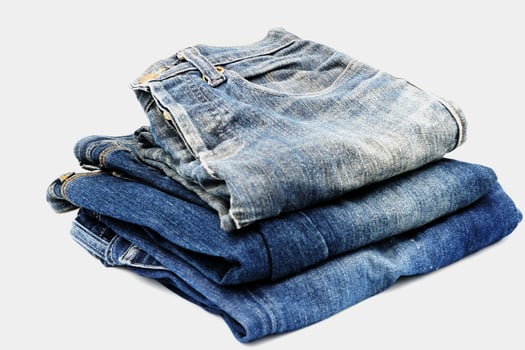 Blue jeans isolated on white background, jeans stacked photo