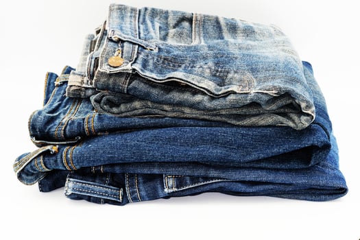Blue jeans isolated on white background, jeans stacked photo
