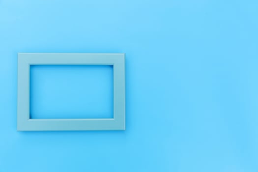 Simply design with empty blue frame isolated on blue pastel colorful background. Top view, flat lay, copy space, mock up. Minimal concept. photo