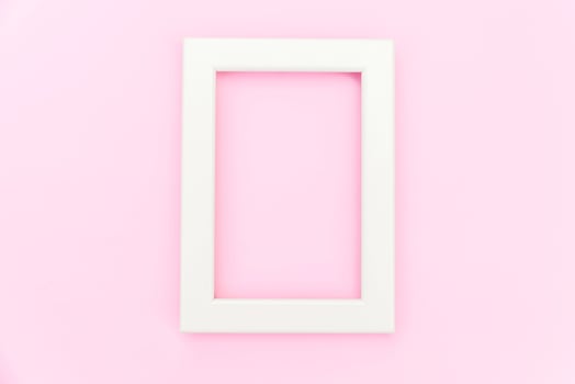 Simply design with empty pink frame isolated on pink pastel colorful background. Top view, flat lay, copy space, mock up. Minimal concept. photo