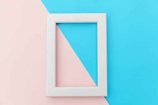 Simply design with empty pink frame isolated on pink and blue pastel colorful background. Top view, flat lay, copy space, mock up. Minimal concept. photo