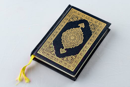 The holy book of Muslims, the Holy Quran, is decorated with gold photo