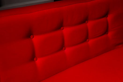 Closeup of a red cushion with buttons photo