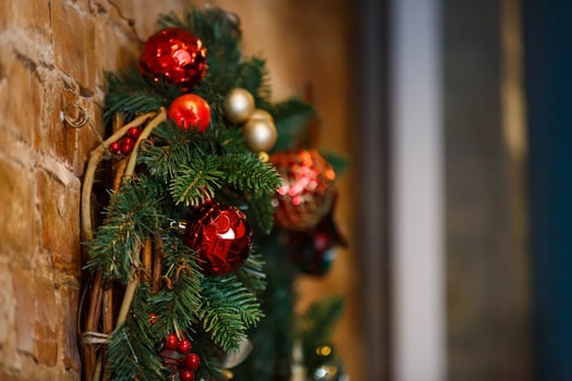 Home made holiday wreath hanging on stone wall. photo