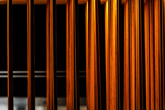 wooden sticks hang from the ceiling against the window photo