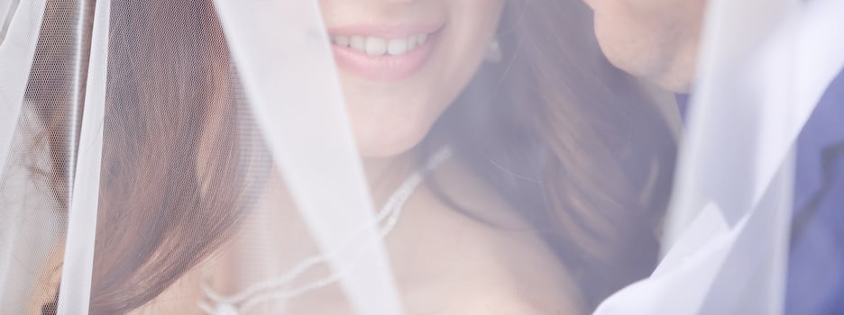 Close up portrait of a pretty shy bride with a veil photo
