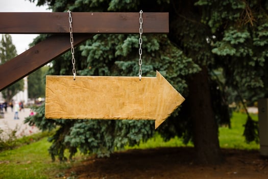 Wooden signboard on nature background photo