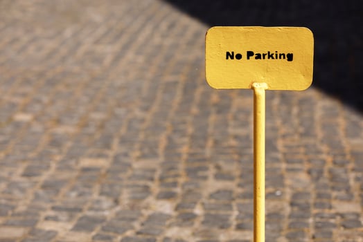 Yellow metal No parking sign on road. selective focus. photo