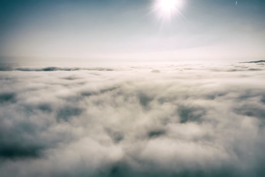 Aerial view white clouds in a blue sky. View from drone. Aerial bird's eye view. The texture of the clouds. View from above. Sunrise or sunset over clouds. photo