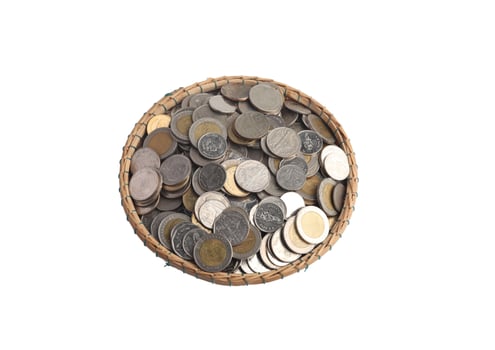 Coins in a bamboo basket on a white background.Saving money concept photo