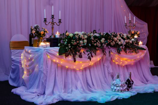 Beautiful wedding restaurant for marriage. White decor for bride and groom. Colorful decoration for celebration. Beauty bridal interior. Bouquet, food and flowers in hall photo