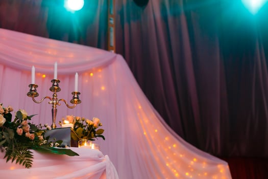 Antique candlestick with wedding bouquet.wedding candlestick with flower decoration before wedding ceremony.Tables set for a wedding reception photo