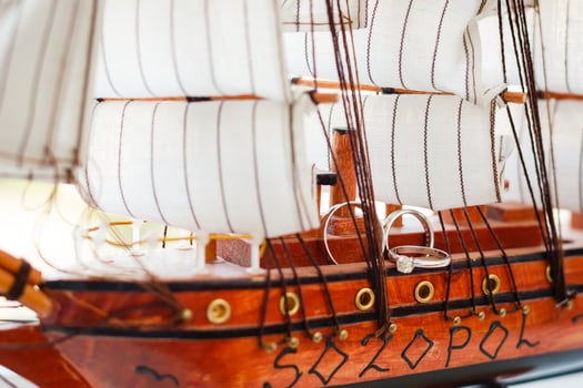Wedding rings in a small boat. Conceptual art photo with a beautiful blur.