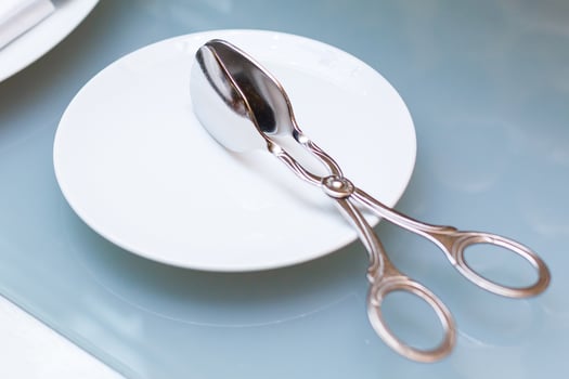 Lot of metal spoon and fork in plate photo