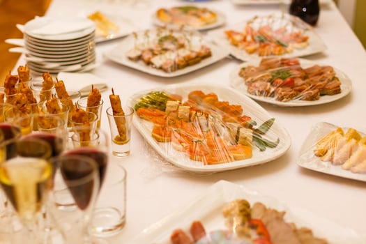 Delicious buffet table at a luxury event spread with a variety of cold meat platters and fresh colorful salad and vegetables photo