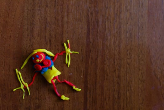 Doll from colorful clay dough plasticine made by child photo