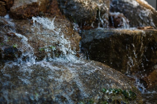 Close up of water splashing on rocks from a waterfall photo