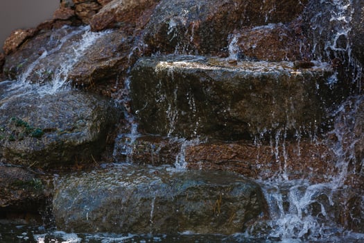 Close up of water splashing on rocks from a waterfall photo