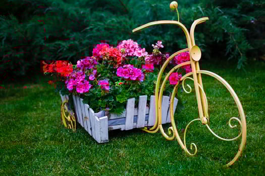 Flower In Basket Of Vintage Old Bicycle near Vintage Wooden Summer Street Cafe in Europe photo