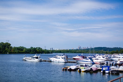 Boats anchored on the bank of the river, across the river residential houses, wide river, rest place photo
