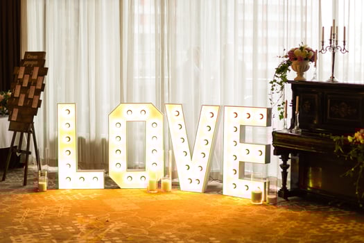 Inscription love from bulbs, Valentine day and christmas background. Blurred word Love for valentine day and merry christmas photo