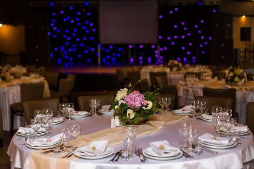 Beautiful table setting with crockery and flowers for a party, wedding reception or other festive event. Glassware and cutlery for catered event dinner. photo
