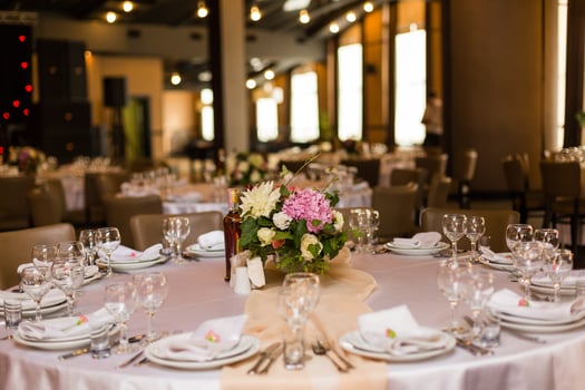 Beautiful table setting with crockery and flowers for a party, wedding reception or other festive event. Glassware and cutlery for catered event dinner. photo