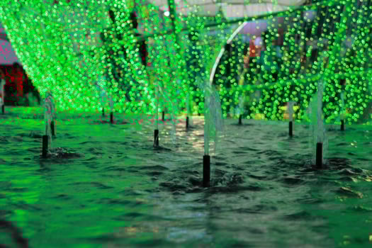 fountain or water dance show at night with colorful light with black background photo