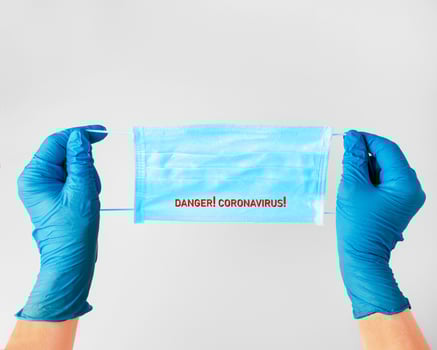 the doctor's hands in rubber gloves hold a medical mask. protection from the virus. coronavirus photo