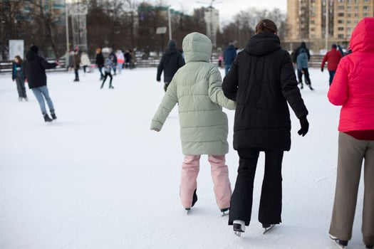 People skate on ice. Winter ice skating. Winter sport. Skates on ice. photo