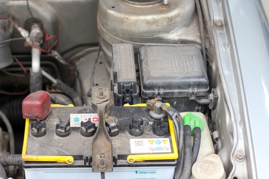 battery and fuse box in the old car engine room photo