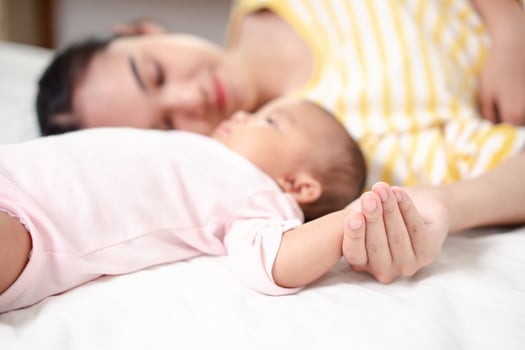 Mother Parenting and newborn birth life. Mom and baby boy playing in sunny bedroom, Family having fun together. childcare, maternity concept. photo