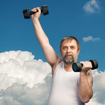 man exercising with dumbbells photo