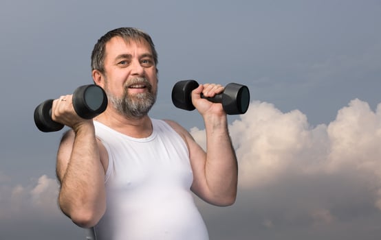 man exercising with dumbbells photo