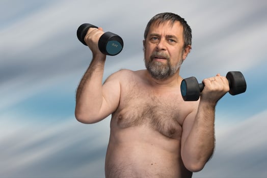 elderly fat man exercising with dumbbells photo