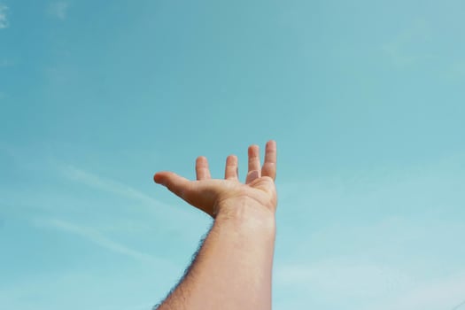 hand up in the air, gesturing in the sky feeling free photo